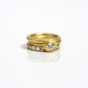 18 carat gold diamond ring stack - single oval diamond ring, eternity ring with pavé-set diamonds and a plain spacer ring